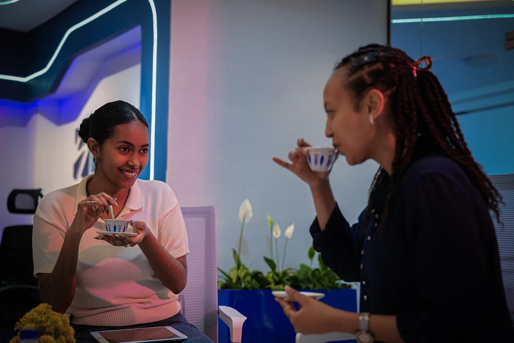 Two Zare team members tasting coffee during the office coffee ceremony