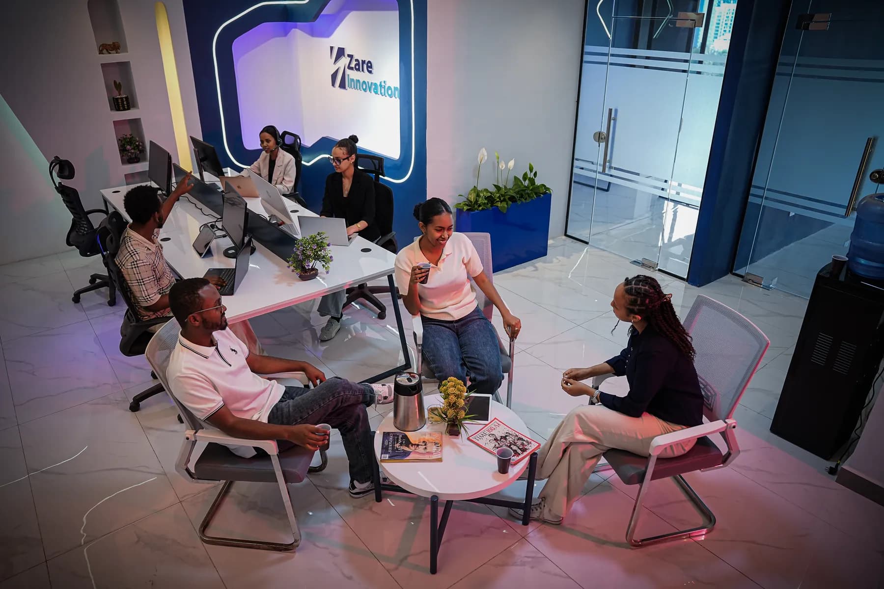 Zare team members talking over coffee in the office lounge